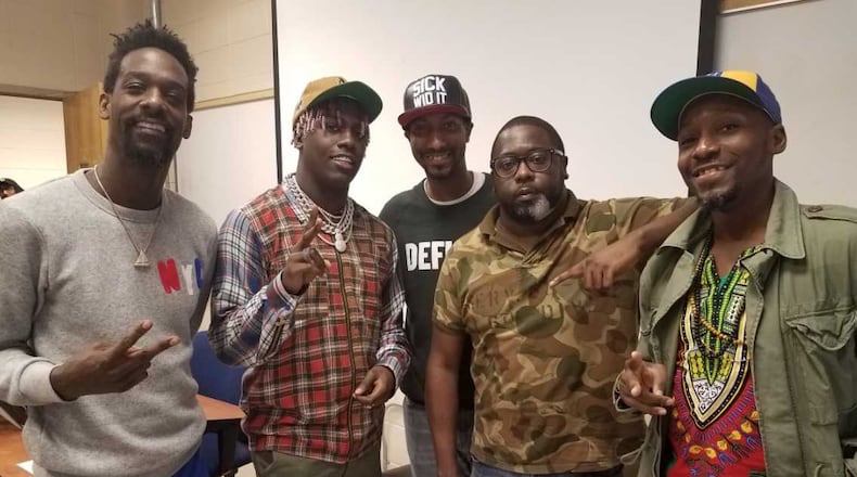 Cobb's Lil Yachty (second from the left) poses with his father, photojournalist Shannon McCollum (far left), Georgia State University professor Christopher Daniel (center) and music journalists Branden Peters and Maurice Garland (far right). The rapper surprised a GSU music journalism class on Oct. 9, 2017.