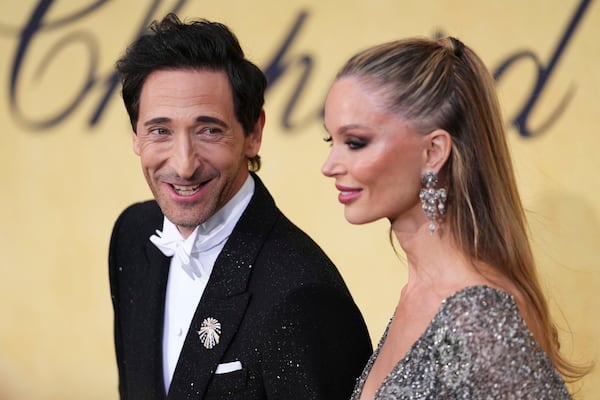 Adrien Brody, left, and Georgina Chapman pose for photographers upon arrival at the amfAR Cinema Against AIDS benefit at the Hotel du Cap-Eden-Roc, during the 78th Cannes international film festival, Cap d'Antibes, southern France, Thursday, May 22, 2025. (Photo by Scott A Garfitt/Invision/AP)
