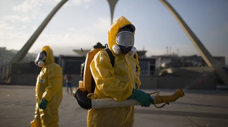 Health workers stand in the Sambadrome in Rio de Janeiro, Brazil, on Jan. 26, 2016, spraying insecticide to combat the mosquito that transmits the Zika virus. Brazil’s health minister says the country will mobilize some 220,000 troops to battle the mosquito blamed for spreading a virus linked to birth defects. (AP Photo/Leo Correa)