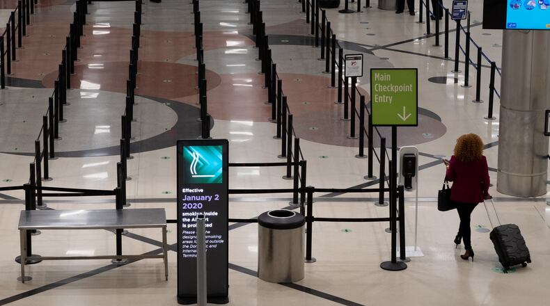 A lone passenger makes her way into the main TSA checkpoint at Hartsfield-Jackson Airport on Friday May 15, 2020. Ben Gray for The Atlanta Journal-Constitution