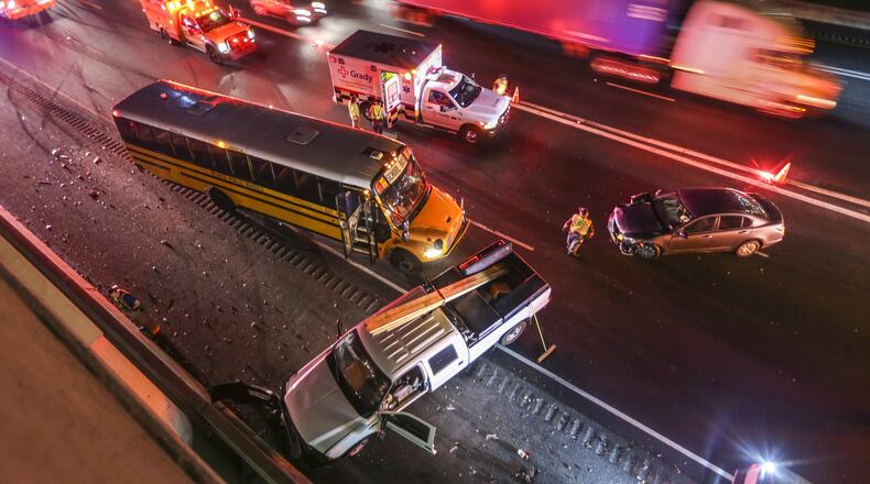 A crash involving a school bus and three other vehicles on Oct. 25 resulted in heavy delays on the Downtown Connector, one injury and a traffic charge for one of the drivers. The only injury was to the driver of the Honda, who was taken to Grady Memorial Hospital and charged with improper lane change. JOHN SPINK /JSPINK@AJC.COM