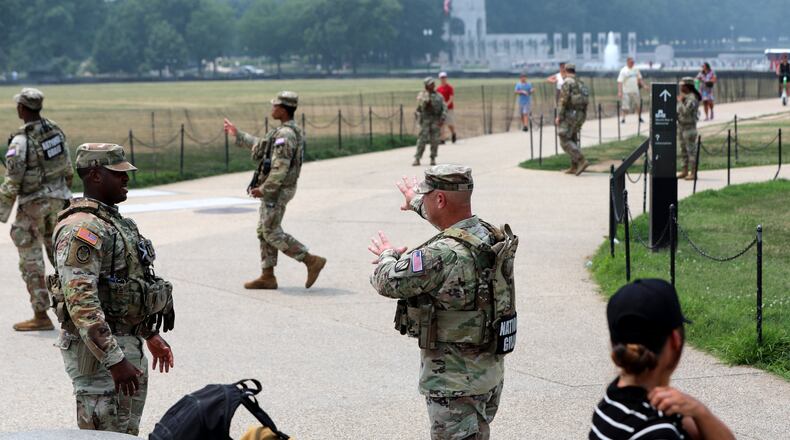 Members of the National Guard patrol around the Washington Monument, before Marine One, with President Donald Trump aboard, departs near the White House, Friday, July 17, 2026, in Washington. (AP Photo/Rahmat Gul)
