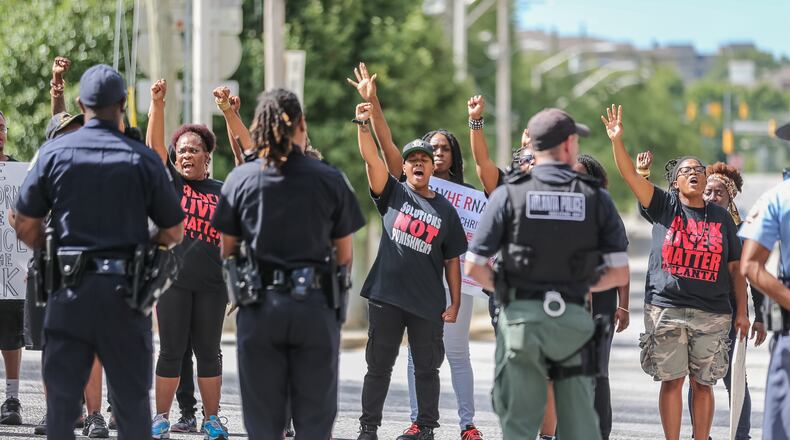 About a dozen Black Lives Matter protesters attempted to get on the Downtown Connector on Wednesday. JOHN SPINK / JSPINK@AJC.COM