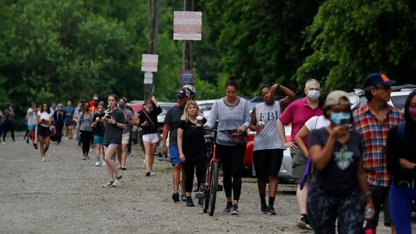 People wait in line to vote in the Georgia's primary election at Park Tavern on Tuesday, June 9, 2020, in Atlanta.