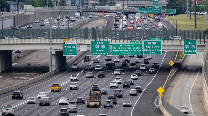 Cars make their way along the Downtown Connector in Atlanta. Auto insurance is one of the largest recurring costs associated with vehicle ownership, McKynzie Steward writes. (Ben Hendren for the AJC)