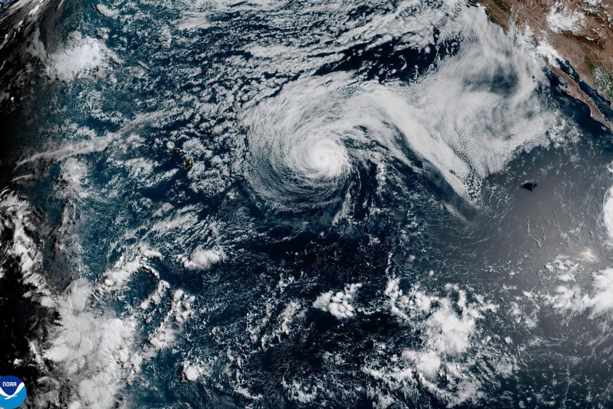 This satellite image released by NOAA shows Hurricane Fausto, center, and Hurricane Genevieve off the southwest coast of Mexico, right, over the Pacific Ocean, Sunday, July 26, 2026. (NOAA via AP)