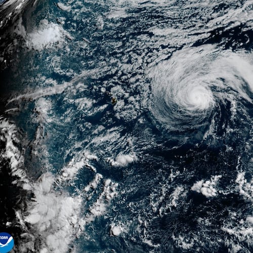 This satellite image released by NOAA shows Hurricane Fausto, center, and Hurricane Genevieve off the southwest coast of Mexico, right, over the Pacific Ocean, Sunday, July 26, 2026. (NOAA via AP)