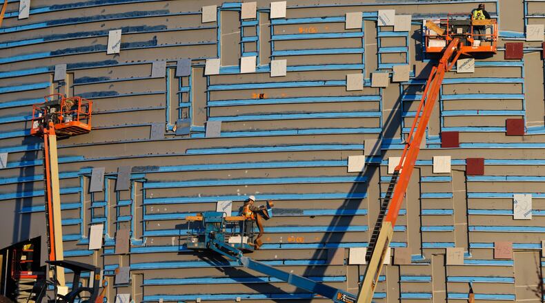 Workers on March, 10, 2014, at the National Center for Civil and Human Rights at Downtown Atlanta's Pemberton Place, adjacent to Centennial Olympic Park, the New World of Coca-Cola and the Georgia Aquarium. The exact location of the 42,000-square-foot facility is the corner of Ivan Allen Boulevard and Centennial Olympic Park Drive. The H.J. Russell & Co., C.D. Moody Construction Co. and Holder Construction Co., three Atlanta-based construction firms, are overseeing construction of the facility. (John Spink/The Atlanta Journal-Constitution)