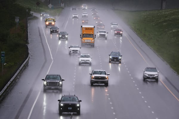 As rain from a nor'easter falls on the pavement, vehicles roll north on Route 93 during the start of the Memorial Day holiday travel, Thursday, May 22, 2025, in Londonderry, N.H. (AP Photo/Charles Krupa)