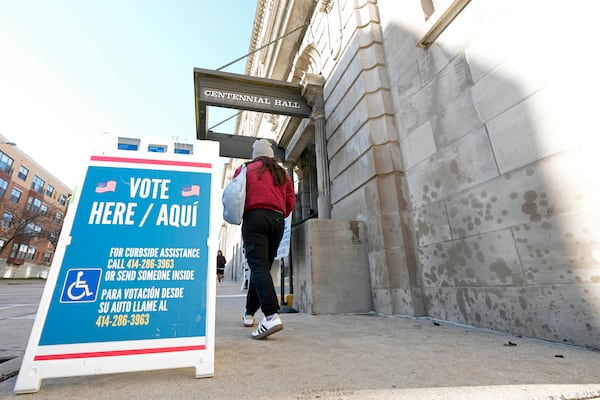 A voter enters Centennial Hall at the Milwaukee Central Library to vote on Election Day Tuesday, April 1, 2025, in Milwaukee. (AP Photo/Kayla Wolf)