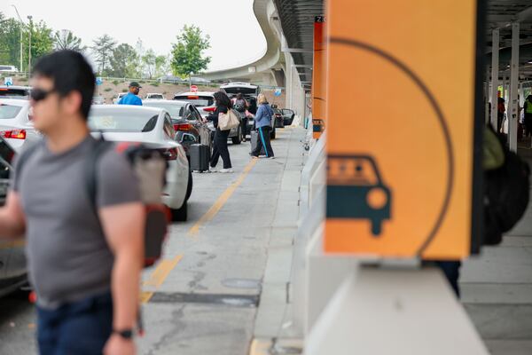 Travelers prepare to depart from the rideshare designated area in the North Terminal at Hartsfield-Jackson Atlanta International Airport on April 24, 2025. (Miguel Martinez/AJC)