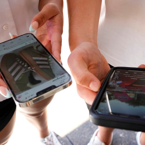 FILE - Young people use their phones to view social media in Sydney, Nov. 8, 2024. (AP Photo/Rick Rycroft, File)