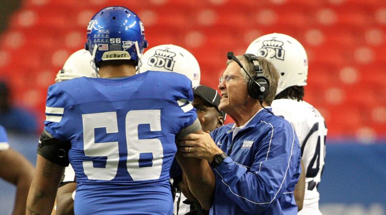 Curry grabs offensive lineman Ulrick John as he separates John from an Old Dominion player in the first half of the game.