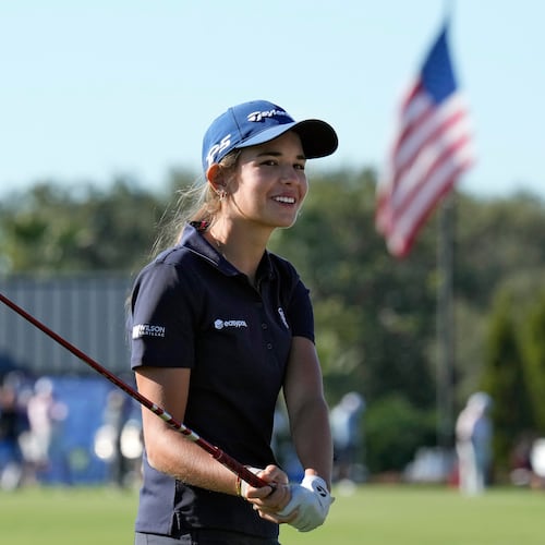 Kai Trump, granddaughter of President Donald Trump, smiles as she waits to hit from the 18th fairway during the first round of The Annika LPGA golf tournament Thursday, Nov. 13, 2025, in Belleair, Fla. (AP Photo/Chris O'Meara)