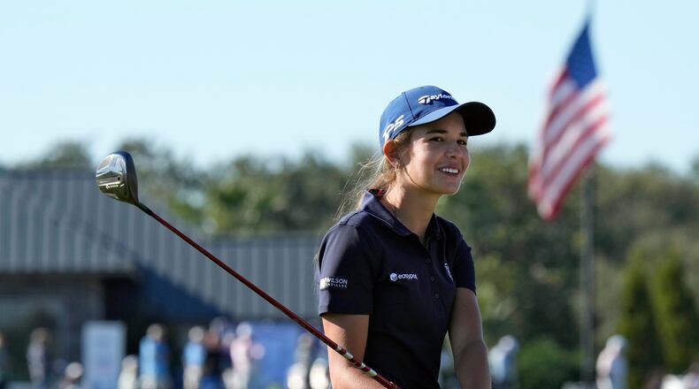 Kai Trump, granddaughter of President Donald Trump, smiles as she waits to hit from the 18th fairway during the first round of The Annika LPGA golf tournament Thursday, Nov. 13, 2025, in Belleair, Fla. (AP Photo/Chris O'Meara)