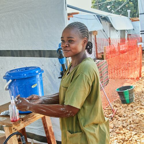 Health workers stand at the Evangelical Medical Center, in Bunia, eastern Congo, Friday, July 3, 2026, where Ebola clinical trials are scheduled to take place. (AP Photo/Dirole Lotsima Dieudonne)