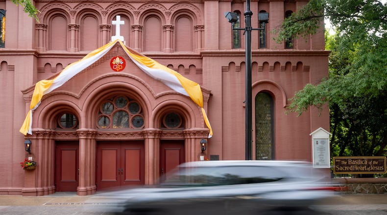 To celebrate the newly elected pope, yellow and white bunting in the colors of the Vatican flag adorn the Basilica of the Scared Heart of Jesus church on Peachtree Street in Atlanta on Friday. (Ben Hendren for the AJC)