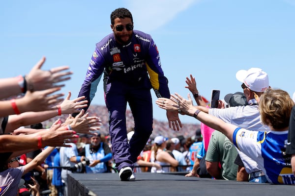 NASCAR Cup Series driver Bubba Wallace greets fans before a NASCAR Cup Series auto race at Talladega Superspeedway, Sunday, April 27, 2025, in Talladega, Ala. (AP Photo/Butch Dill)