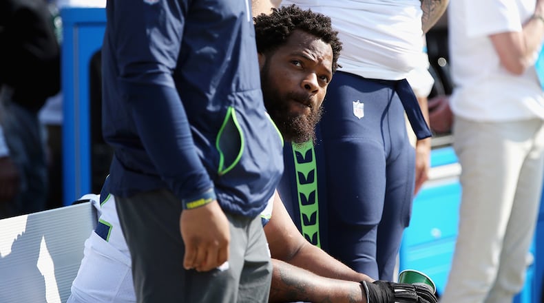 GREEN BAY, WI - SEPTEMBER 10: Michael Bennett #72 of the Seattle Seahawks sits on the bench during the national anthem prior to the game against the Green Bay Packers at Lambeau Field (Photo by Dylan Buell/Getty Images)