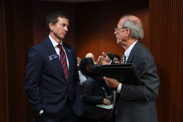 State Sen. Greg Dolezal (left) and election integrity activist Garland Favorito speak before a House Governmental Affairs Committee meeting earlier this week. (Arvin Temkar/AJC)