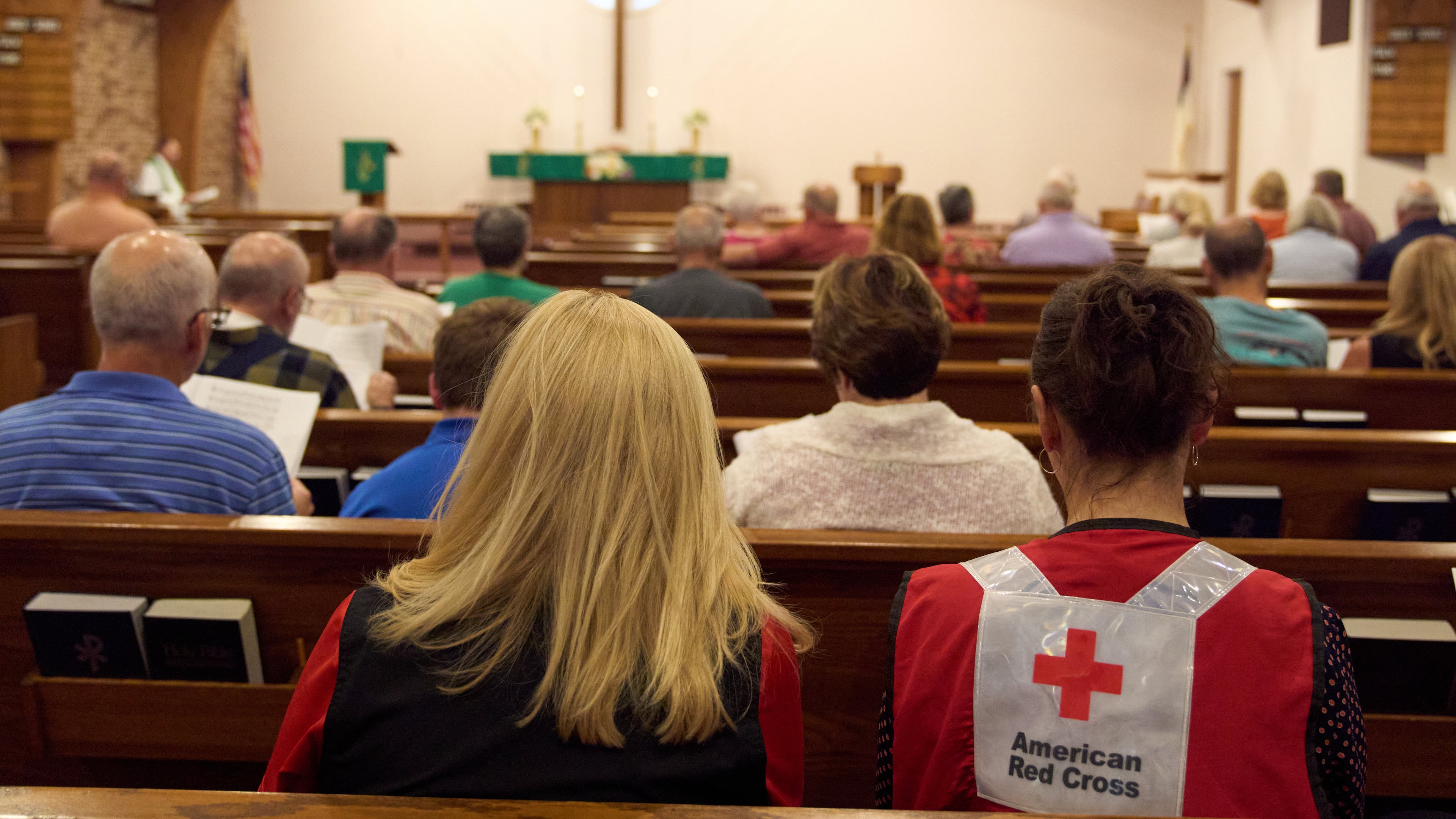 A woman wearing an American Red Cross shirt is seen during a service for the Sunday morning shooting at The Church of Jesus Christ of Latter-day Saints in Grand Blanc Township, Mich., Monday, Sept. 29, 2025. (AP Photo/Ryan Sun)