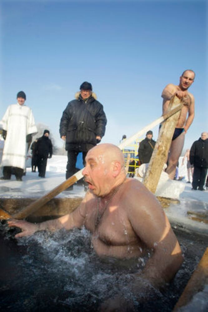 Think it's cold? Russians plunge into ice bath