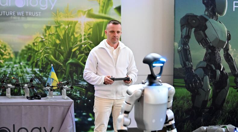 Vadym Kalinichenko, event attendee from Ukraine, controls Futurology Tech’s Unitree robot using a remote controller during Launch Pad Tech Collaboration Event, hosted with Georgia Tech, Partnership Gwinnett, and Peachtree Corners Curiosity Lab, Thursday, March 20, 2025, in Norcross. (Hyosub Shin / AJC)