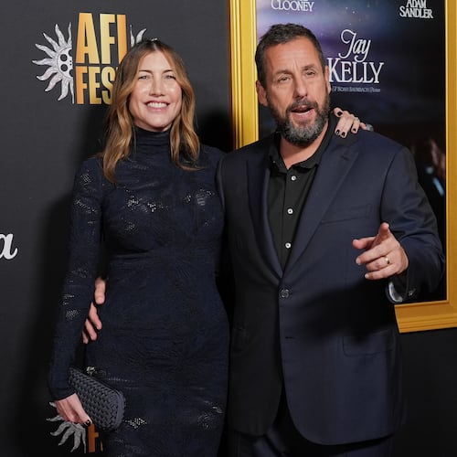 Adam Sandler, right, a cast member in "Jay Kelly," arrives with his wife Jackie Sandler at the AFI Fest premiere of the film on Thursday, Oct. 23, 2025, at TCL Chinese Theatre in Los Angeles. (AP Photo/Chris Pizzello)