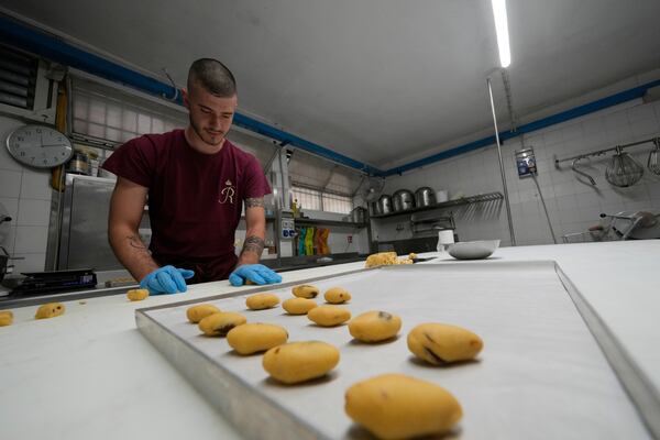 Pastry chef Elias prepares traditionals Zaletti biscuits at the Andrea Rosa Salva pastry kitchen, in Venice, Italy, Thursday, June 12, 2025. (AP Photo/Luca Bruno)