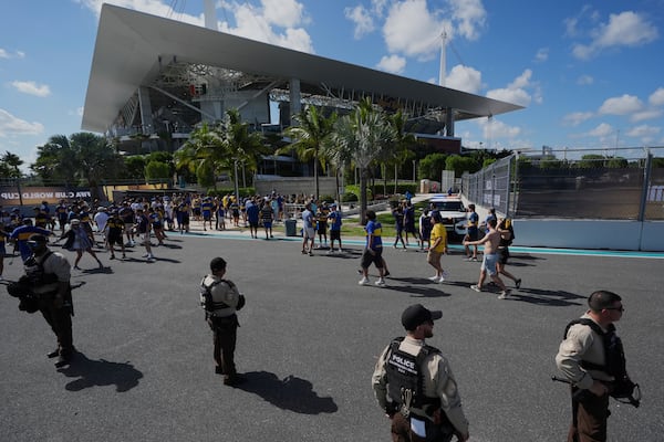 Law enforcement personnel stand outside the stadium prior to the Club World Cup group C soccer match between Boca Juniors and Benfica in Miami Gardens, Fla., Monday, June 16, 2025. (AP Photo/Rebecca Blackwell)
