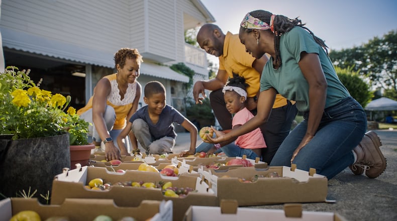Jamila Norman and the Abbott family look at specialty tomatoes, as seen on Homegrown, season 2.