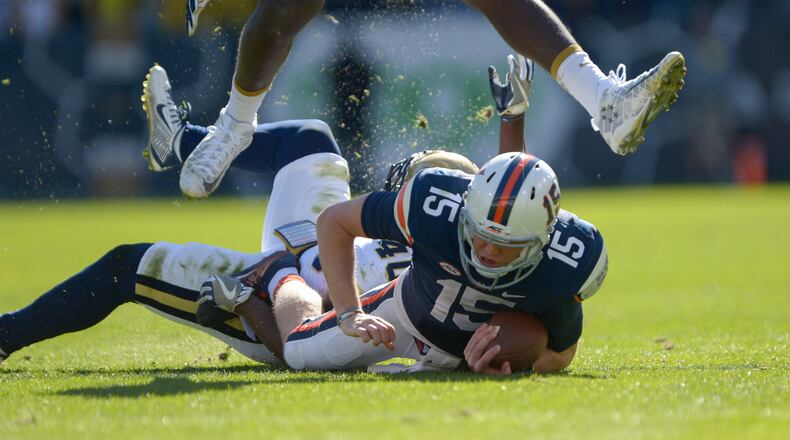 Virginia senior QB Matt Johns #15 hits the ground after being tackled by Georgia Tech senior LB P.J. Davis #40 during the first half of the game Saturday, November 19, 2016. SPECIAL/Daniel Varnado
