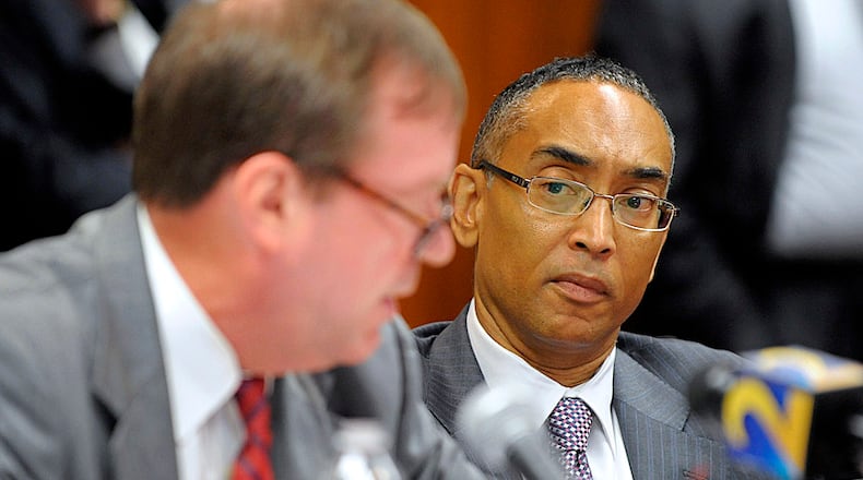 DeKalb County CEO Burrell Ellis, right, listens as attorney Craig Gillen responds to a 14-count indictment at a hearing to determine if the charges against Ellis will interfere with his job running the state's third-largest county, July 15, 2013.