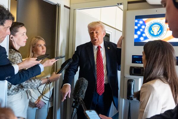 President Donald Trump speaks to reporters aboard Air Force One en route from Riyadh, Saudi Arabia to Doha, Qatar, Wednesday, May 14, 2025. (AP Photo/Alex Brandon)