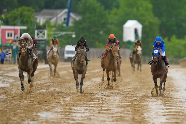 Margie's Intention, far left, with jockey Flavien Prat, edges out Paris Lily, with jockey Joel Rosario, to win the 149th running of the Black-Eyed Susan horse race Friday, May 16, 2025, in Baltimore. (AP Photo/Nick Wass)