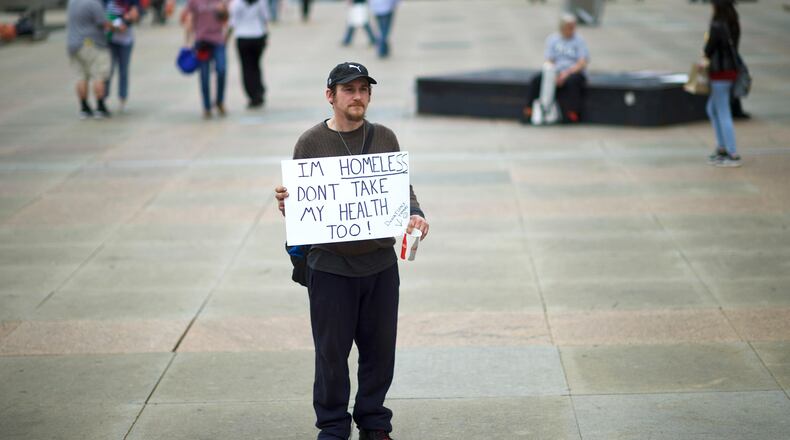 FILE PHOTO: A man carries a sign reading "I'm homeless, don't take my health too!" before a health care rally at Thomas Paine Plaza on February 25, 2017 in Philadelphia, Pennsylvania. (Photo by Mark Makela/Getty Images)