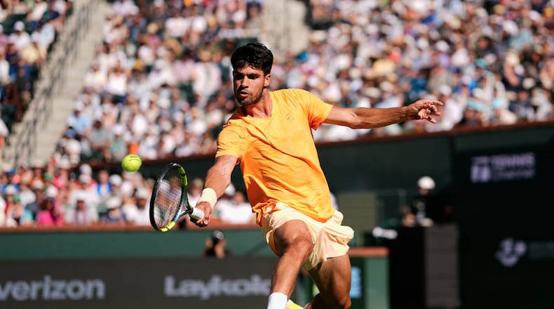 FILE - Carlos Alcaraz, of Spain, returns a shot against Daniil Medvedev, of Russia, during a semifinal match at the BNP Paribas Open tennis tournament, March 14, 2026, in Indian Wells, Calif. (AP Photo/Mark J. Terrill, File)