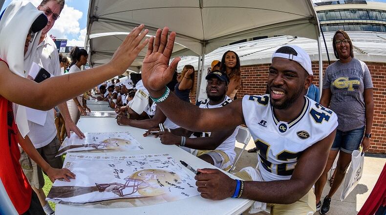 Georgia Tech defensive end KeShun Freeman (42) high-fives a fan during Fan Day at Bobby Dodd Stadium on Aug. 12, 2017. -- Danny Karnik/GT Athletics