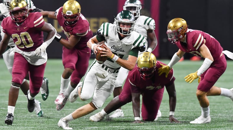Collins Hill quarterback Sam Horn (21) runs with the ball against Brookwood during the 2021 Corky Kell Classic Saturday, Aug. 21, 2021, at Mercedes-Benz Stadium in Atlanta. Horn rushed for 44 yards and a score in addition to 31-of-44 passing for 402 yards and three touchdowns. (Hyosub Shin / Hyosub.Shin@ajc.com)