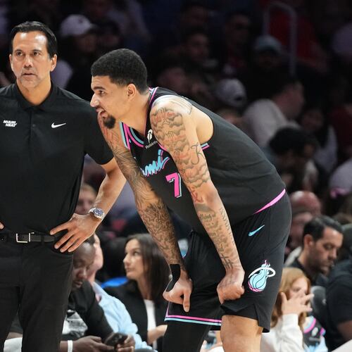 Miami Heat head coach Erik Spoelstra listens to center Kel'el Ware (7) during the second half of an NBA basketball game against the Washington Wizards Saturday, April 4, 2026, in Miami. (AP Photo/Marta Lavandier)