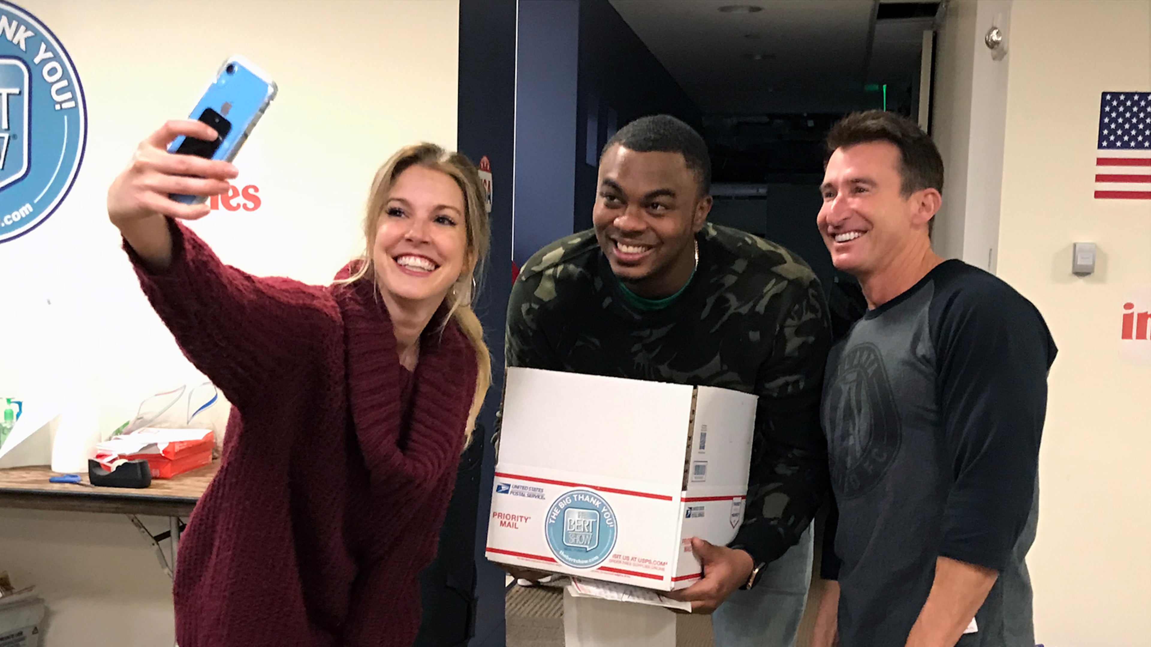 Radio hosts Kristin Klingshirn (left), Moe Mitchell (center) and Bert Weiss in November 2019 during a charity event where the "Bert Show" collected letters for American military overseas during Thanksgiving. (Rodney Ho/AJC 2019)