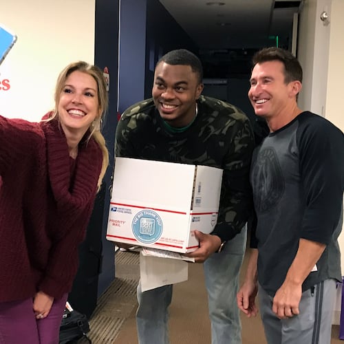 Radio hosts Kristin Klingshirn (left), Moe Mitchell (center) and Bert Weiss in November 2019 during a charity event where the "Bert Show" collected letters for American military overseas during Thanksgiving. (Rodney Ho/AJC 2019)