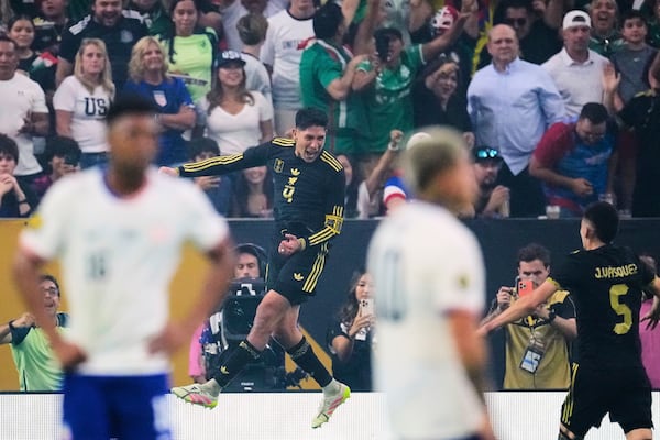 Mexico midfielder Edson Álvarez (4) leaps as he celebrates after scoring against the United States as Johan Vásquez (5) looks on in the second half of the CONCACAF Gold Cup final soccer match in Houston, Sunday, July 6, 2025. (AP Photo/David J. Phillip)