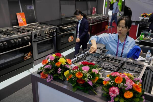 Workers cleans stoves on display at the 137th Canton Fair in Guangzhou in southern China's Guangdong province on Wednesday, April 16, 2025. (AP Photo/Ng Han Guan)