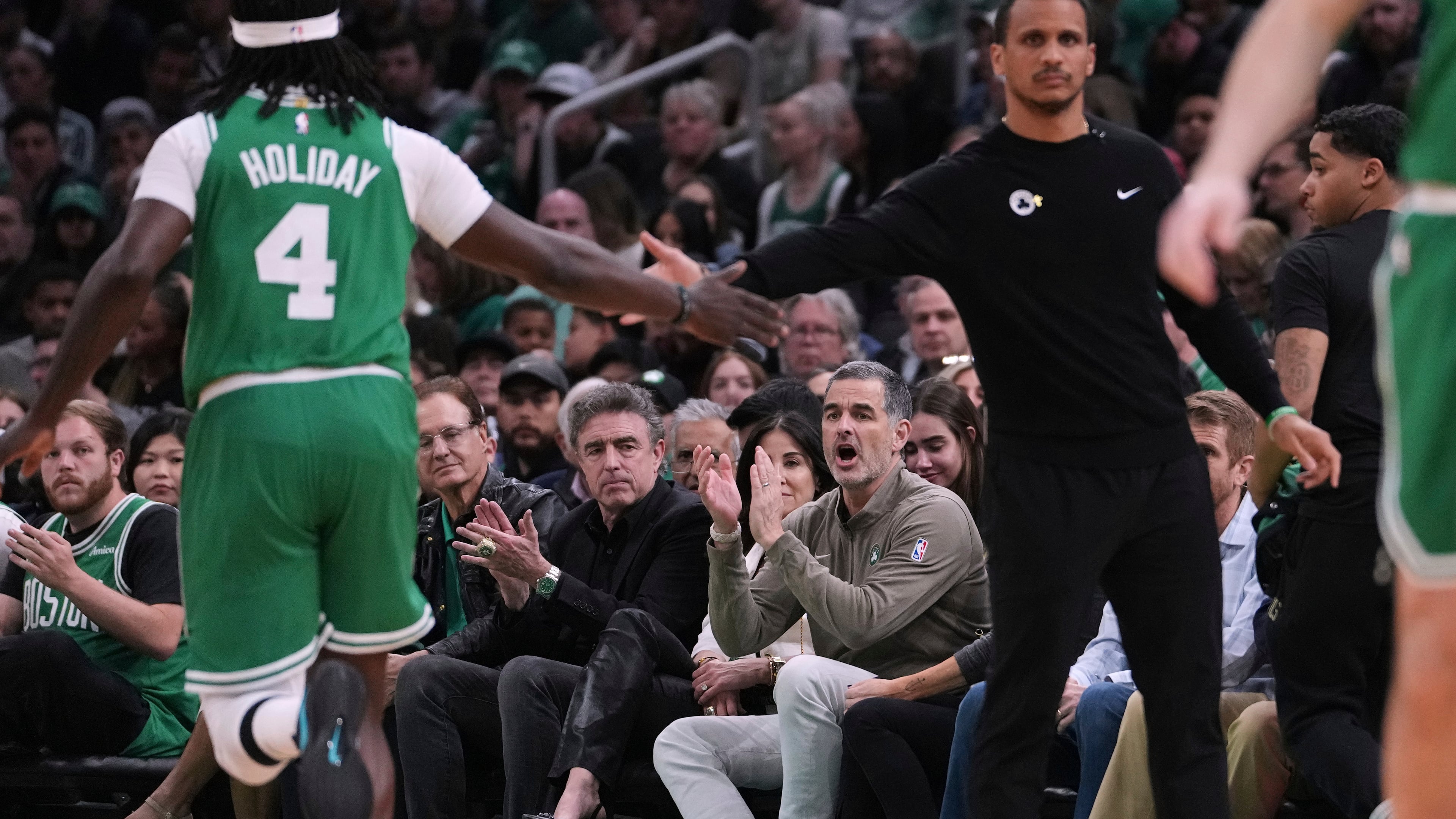 FILE - Boston Celtics owner Bill Chisholm, seated right, applauds during the first half in game 2 of a first-round NBA playoff basketball series against the Orlando Magic, April 23, 2025, in Boston. (AP Photo/Charles Krupa, File)