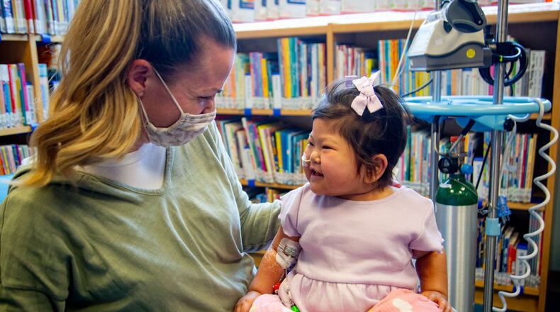 Tamara Harris and her daughter Rynli visited the library at Children's Healthcare of Atlanta - Egleston Hospital recently after Rynli's surgery. STEVE SCHAEFER FOR THE AJC