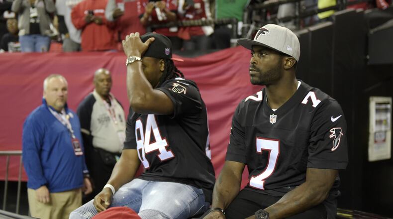 Former Falcons quarterback Michael Vick (7) greets fans at the Georgia Dome during the NFL football game against the Saints in Atlanta, Georgia, on Sunday, January 1, 2017. (DAVID BARNES / DAVID.BARNES@AJC.COM)