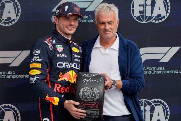 Red Bull driver Max Verstappen of the Netherlands and a soccer coach Jose Mourinho pose after the qualifying for the British Formula One Grand Prix in Silverstone, England, Saturday, July 5, 2025. (AP Photo/Darko Bandic)