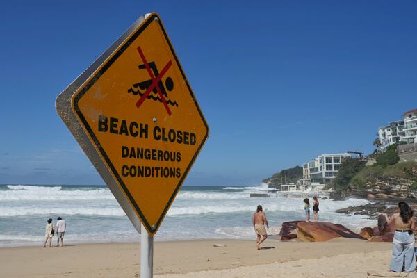 A sign shows beach closed as large swells hit Sydney's Bondi Beach Wednesday, April 2, 2025. (AP Photo/Mark Baker)