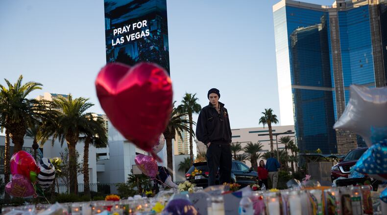Matthew Helms, who worked as a medic the night of the shooting, visits a makeshift memorial for the victims of Sunday night's mass shooting, on the north end of the Las Vegas Strip, October 3, 2017 in Las Vegas, Nevada. (Photo by Drew Angerer/Getty Images)